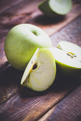 apple on the brown wood floor.