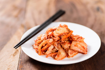 Korean food, kimchi cabbage on white dish with chopsticks for eating.Healthy food
