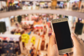 people's hands playing ,using a mobile phone in the mall.