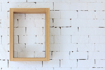 Brown wood frame on white brick background.