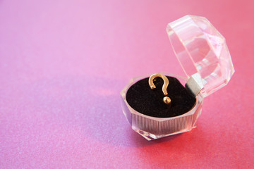 Engagement proposal ring in the shape of a question mark. Concept for doubt about marriage. Will you marry me? Will he propose? Yes or no?