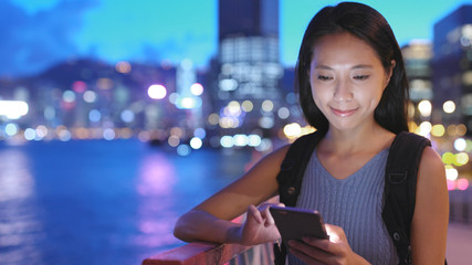 Woman travel in Hong Kong with her cellphone