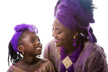 Mother and child girl looking to each other.African traditional clothing .Isolated