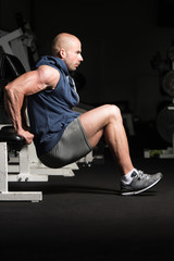 Fototapeta na wymiar Man On Bench Exercising Triceps