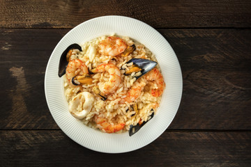 Seafood risotto on dark rustic background with copyspace © laplateresca