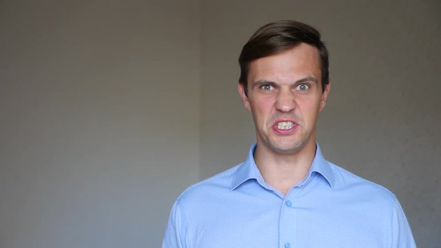 4k. Slow motion. Close up portrait of a young man. body language and gestures. he gets angry and yells at the camera