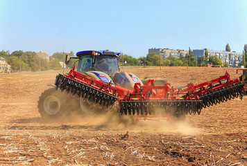 Work of a powerful tractor in field cultivation and cultivation. Agronomy,