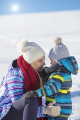 Attractive family having fun in a winter park on mountain