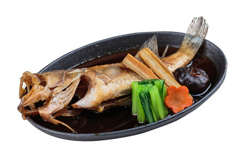 Isolated Fried snapper with radish, carrot, shiitake and choy sum in hot plate.