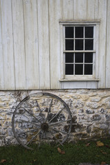 Obraz premium old stone and wood building with wagon wheel at Hopewell Furnace in Pennsylvania
