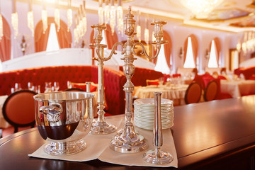 Silver candlesticks and a bucket for chilling champagne. Exclusive restaurant serving