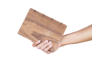 Hand holding hand made book isolated on white background. Clipping path. .Hand made book is beautiful to use for everyone because it looks great to write. Use for writing notes or writing diary.