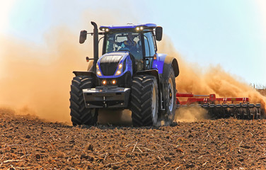 Fototapeta premium tractor working in the field. Tractor plow field Agriculture.