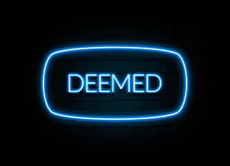 Deemed  - colorful Neon Sign on brickwall