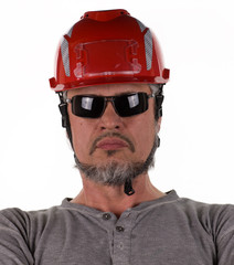 studio portrait of a worker in a construction helmet
