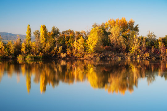 Bunte Bäume im Herbst spiegeln sich im See © Ewald Fröch