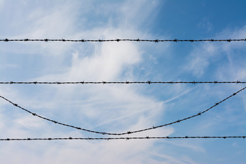 Barbed Wire in the sky with clouds