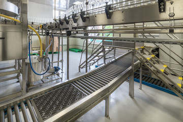 Curved belt conveyors for transportation of glass bottles.