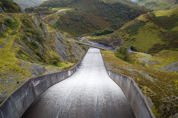 The overflow at Llyn Brianne Reservoir in Wales. The spillway of the dam is a notable tourist attraction when the reservoir is spilling. The dam is the UK's tallest, standing at a height of 91m 