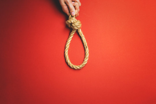 The man tightens the noose