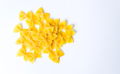 Uncooked bow tie pasta on white
