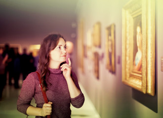 Intelligence woman visiting museum and pleased arts
