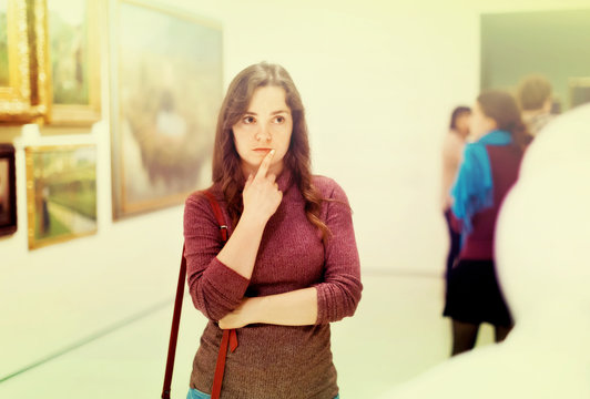 Closeup on attentive woman visiting museum and enjoying sculture