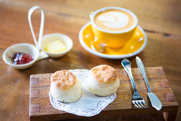 Set of latte art and cookie on wooden plate