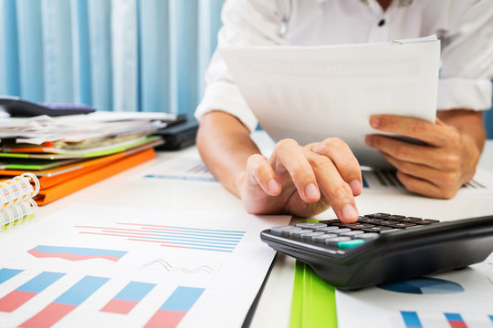 Vat and loan rates calculated by the bank of according to the tax code of the government. Business man asian hard working in the office calculating tax income.
