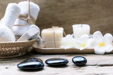 Black zen stones,beauty and skincare products  products on wooden background