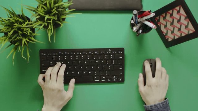 Top view shot of man using keyboard and mouse with green screen