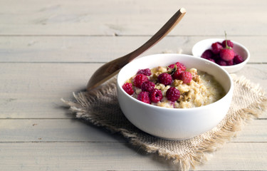 Breakfast with oatmeal and fresh raspberries.