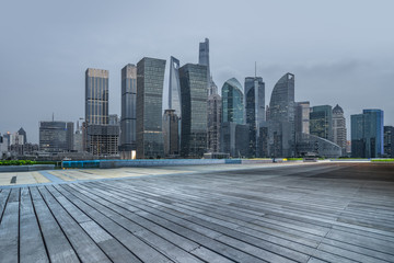 night view of empty wooden footpath with shanghai cityscape and skyline