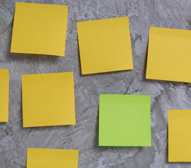 Colourful post it over rustic concrete wall background