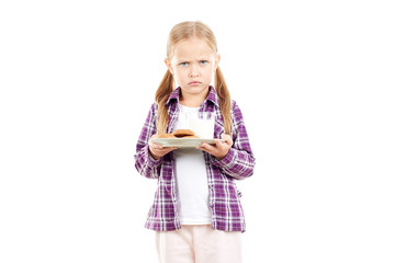 Portrait of little girl holding plate with cookies