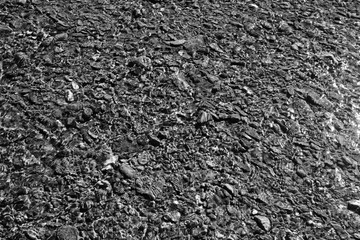 texture of water on stones in a crooked stream