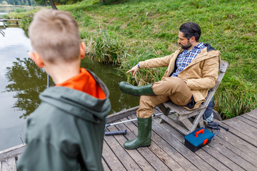 Father and son fishing with rods