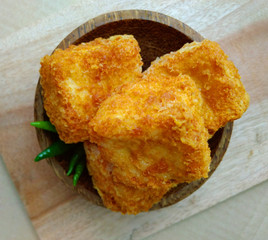 Flat Lays or top view, tahu sumedang (Fried Tofu) from west java,  indonesia with green hot chili at Wooden small bowl