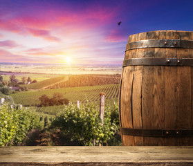 Red wine with barrel on vineyard in green Tuscany, Italy