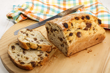 currant bread cut in to slices on wooden board