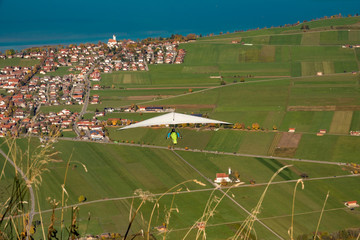 Fototapeta na wymiar Hang gliding in Bavaria, Germany after jumping from Mount Tegelberg down towards the Forggensee.