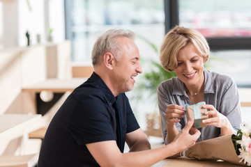 Man presenting gift to woman