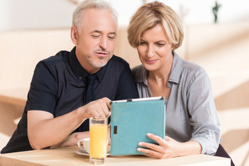 Couple looking something at tablet