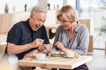Couple eating sweets at cafe