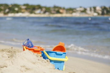 Fototapeta na wymiar Toys on the beach near a sea