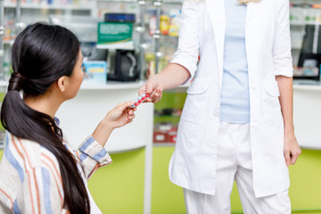 pharmacist giving medication to customer