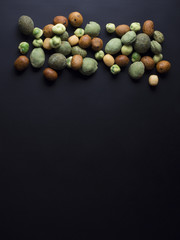 Japanese wasabi crackers in different colors isolated on black background