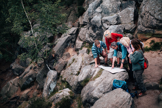 Group of mixed age people resting on hike