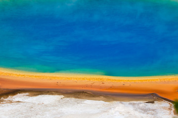 Obraz premium Famous trail of Grand Prismatic Springs in Yellowstone National Park from high angle view. Beautiful hot springs with vivid color blue green orange in Wyoming.