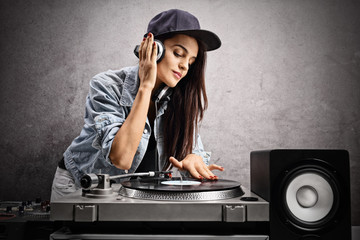 Female DJ playing music on a turntable